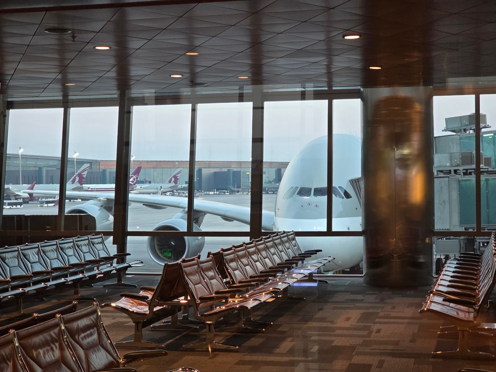 Airport waiting areas with seating and natural light.
